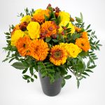 Flower arrangement with roses, mini gerbera, calendula and rose hips
