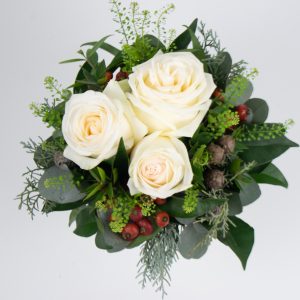 Flower arrangement with roses, eucalyptus and rose hips